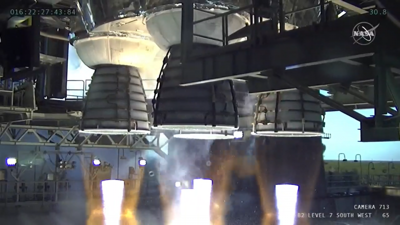 Ground level view of 4 large down-firing rocket engines.