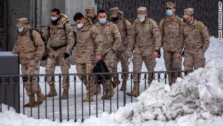 Members of the military walk through the snow in central Madrid, Spain, Sunday, January 10.